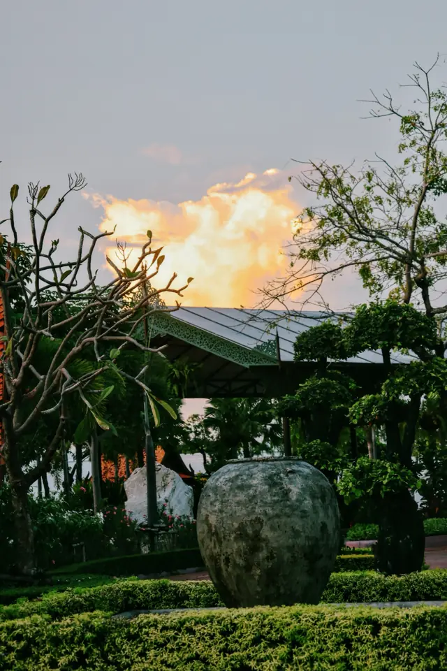 A garden at dusk with a stone urn