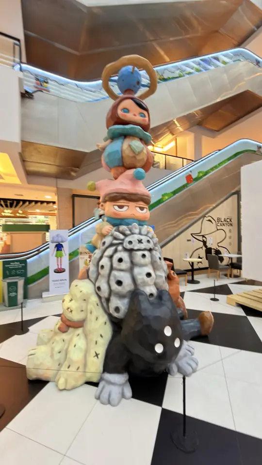 A stacked designer toy sculpture in a shopping mall