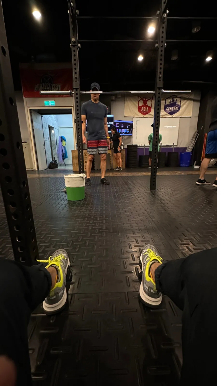 A class seen from the floor, through the uprights of a rack